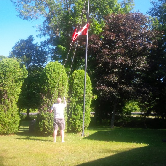 Mike raising the flag for Canada Day